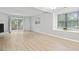 Living room with fireplace, sliding glass doors, and light-toned laminate flooring at 6703 Jefferson Pl. # B7, Myrtle Beach, SC 29572