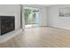 Spacious living room with fireplace, sliding doors to patio, and laminate flooring at 6703 Jefferson Pl. # B7, Myrtle Beach, SC 29572
