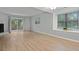 Spacious living room features a fireplace, wood-style flooring, and sliding doors to an outdoor patio at 6703 Jefferson Pl. # B7, Myrtle Beach, SC 29572