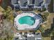 Aerial view of a sparkling community pool surrounded by well-maintained landscaping and residential buildings at 6703 Jefferson Pl. # B7, Myrtle Beach, SC 29572