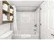 Bathroom featuring a toilet, bathtub with shower, and shelves with neatly folded towels at 7100 N Ocean Blvd. N # 601, Myrtle Beach, SC 29572