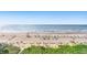 Aerial view of beach, ocean, beach umbrellas, and writing in the sand at 7100 N Ocean Blvd. N # 601, Myrtle Beach, SC 29572