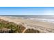 Ocean view with sandy beach, dunes, and scattered trees and greenery at 7100 N Ocean Blvd. N # 601, Myrtle Beach, SC 29572