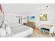 Bright bedroom with two beds, dining table, a mounted TV, and a full kitchen behind the bedroom at 7100 N Ocean Blvd. N # 601, Myrtle Beach, SC 29572