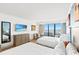 Bright bedroom featuring two beds, a mounted TV, a dining table, and balcony with ocean view at 7100 N Ocean Blvd. N # 601, Myrtle Beach, SC 29572