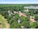 Aerial view of a lush neighborhood in a wooded area with a pond at 752 Tall Oaks Ct., Myrtle Beach, SC 29588