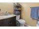 Bathroom with sink, toilet, storage shelves, and decorative towels at 752 Tall Oaks Ct., Myrtle Beach, SC 29588
