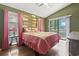 This bedroom features wood floors, views to the outside balcony and unique decorative paddles on the wall at 752 Tall Oaks Ct., Myrtle Beach, SC 29588