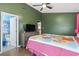 Cozy bedroom featuring a colorful quilt, wood floors, and adjacent bathroom access at 752 Tall Oaks Ct., Myrtle Beach, SC 29588