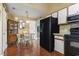 Dining room featuring wood flooring, vintage cabinet, and black appliances at 752 Tall Oaks Ct., Myrtle Beach, SC 29588