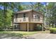 Exterior shot of house with elevated design and surrounding greenery at 752 Tall Oaks Ct., Myrtle Beach, SC 29588