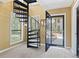 Entry foyer with open door, a spiraling staircase, and natural light at 752 Tall Oaks Ct., Myrtle Beach, SC 29588