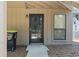 Front entrance with a screen door and neutral-colored siding at 752 Tall Oaks Ct., Myrtle Beach, SC 29588