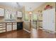 Kitchen featuring black appliances, light counters, and wood-look flooring at 752 Tall Oaks Ct., Myrtle Beach, SC 29588