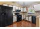 Kitchen featuring black appliances, white cabinets, and wood flooring at 752 Tall Oaks Ct., Myrtle Beach, SC 29588