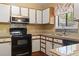 Well-lit kitchen featuring black appliances, light counters, and tile backsplash at 752 Tall Oaks Ct., Myrtle Beach, SC 29588