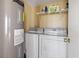 Laundry room with washer, dryer, hot water heater, and shelving at 752 Tall Oaks Ct., Myrtle Beach, SC 29588