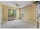 Inviting living room with neutral carpet, ceiling fan, and sliding glass doors to a patio at 752 Tall Oaks Ct., Myrtle Beach, SC 29588