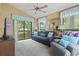 Comfortable living room with large windows, ceiling fan, and neutral carpet at 752 Tall Oaks Ct., Myrtle Beach, SC 29588