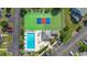 Aerial view showcasing the pool, cabana, tennis and pickleball courts, and parking area at 775 Plantation Dr. # 28, Little River, SC 29566