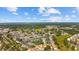 This aerial view showcases a neighborhood with lush landscaping, a pond, and community pool under a sunny sky at 775 Plantation Dr. # 28, Little River, SC 29566