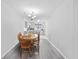 This dining area features a wooden table and chairs and is adjacent to a kitchen with white cabinets and a gray countertop at 775 Plantation Dr. # 28, Little River, SC 29566