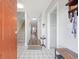 Inviting foyer with tile floors, staircase, and view of the living area with hardwood floors at 775 Plantation Dr. # 28, Little River, SC 29566