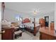 Spacious bedroom featuring a ceiling fan, plenty of natural light, and wood furniture at 775 Plantation Dr. # 28, Little River, SC 29566
