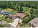 Stunning aerial view of the home showcasing its brick exterior, three-car garage, and meticulously landscaped surroundings at 784 Caines Landing Rd., Conway, SC 29526