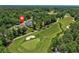 Aerial view showing home's location near a lush green golf course featuring mature trees and manicured lawns at 784 Caines Landing Rd., Conway, SC 29526