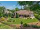 Extensive backyard featuring lush landscaping, inviting patio, and stone chimney on this beautifully maintained property at 784 Caines Landing Rd., Conway, SC 29526