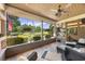 Inviting covered patio featuring tile flooring, ceiling fan, outdoor kitchen, and views of the landscaped yard and golf course at 784 Caines Landing Rd., Conway, SC 29526