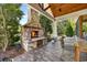 Beautiful stone fireplace and wood ceiling in a covered outdoor space, complemented by lush backyard views and ample natural light at 784 Caines Landing Rd., Conway, SC 29526