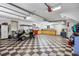 Spacious garage featuring ample storage, a workbench, and a stylish checkered floor, perfect for car enthusiasts at 784 Caines Landing Rd., Conway, SC 29526