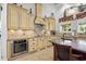 The gourmet kitchen has stainless steel appliances, custom cabinetry, and a tile backsplash at 784 Caines Landing Rd., Conway, SC 29526