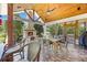 Inviting outdoor kitchen with stone fireplace, featuring wood ceiling, ample seating, and views of the surrounding landscape at 784 Caines Landing Rd., Conway, SC 29526