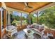 Cozy screened-in porch featuring a wood ceiling, comfortable seating, and views of the manicured backyard at 784 Caines Landing Rd., Conway, SC 29526