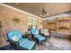 Relaxing screened porch with comfortable seating, ceiling fan, and brick accent wall, ideal for enjoying the outdoors at 784 Caines Landing Rd., Conway, SC 29526