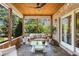 Relaxing screened-in porch with wood ceiling, brick accents, comfortable seating, and views of the lush, green backyard at 784 Caines Landing Rd., Conway, SC 29526