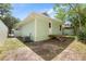 Green backyard featuring wood decks, an exterior door, and an air conditioning unit for comfort at 814 Night Heron Ln., Myrtle Beach, SC 29572