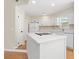 Well-lit kitchen features a central island with a smooth cooktop and a clean white design at 814 Night Heron Ln., Myrtle Beach, SC 29572