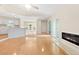 Bright, open-concept living room with hardwood floors, a fireplace, and seamless flow to the kitchen at 814 Night Heron Ln., Myrtle Beach, SC 29572