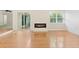 Bright living room with hardwood floors, modern fireplace, and sliding door access to the deck at 814 Night Heron Ln., Myrtle Beach, SC 29572