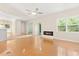 Open living room featuring hardwood floors, a modern fireplace, and seamless access to other rooms at 814 Night Heron Ln., Myrtle Beach, SC 29572
