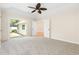 Relaxing main bedroom boasts soft carpet, slider access to backyard, and a ceiling fan at 814 Night Heron Ln., Myrtle Beach, SC 29572