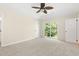 Relaxing main bedroom boasts soft carpet, slider access to backyard, and a ceiling fan at 814 Night Heron Ln., Myrtle Beach, SC 29572