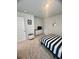 Cozy bedroom with striped bedding, neutral walls, and minimalist decor at 8211 Forest Edge Dr., Myrtle Beach, SC 29579