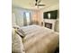 Cozy main bedroom featuring a fireplace, TV, ceiling fan, and neutral tones at 8211 Forest Edge Dr., Myrtle Beach, SC 29579