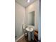 A practical powder room featuring a pedestal sink, mirror, and decorative elements at 8211 Forest Edge Dr., Myrtle Beach, SC 29579