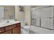 Well-lit bathroom with a tub-shower combo, single sink vanity, and tile flooring at 8855 Radcliff Dr. Nw # 53C, Calabash, NC 28467